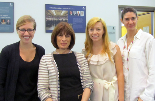 4 Women standing in a row facing the camera. Caption has their names.