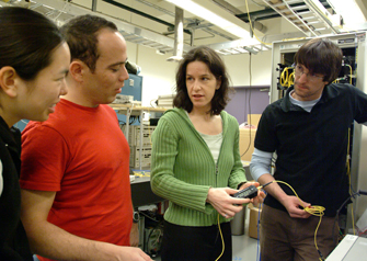 students working with professor in the lab