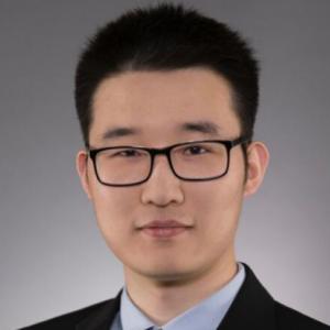 A photo of a young man with black hair and black glasses