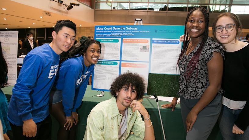 The Columbia Engineering seniors who designed the Moss Could Save The Subway project posing in front of their presentation poster