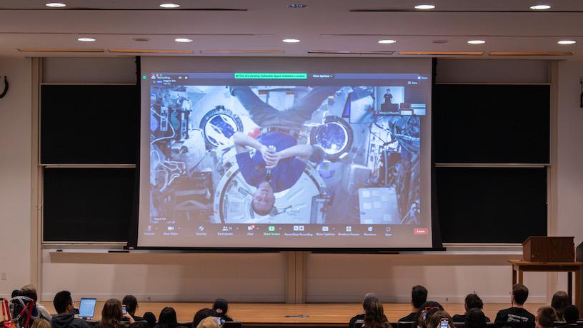 Students watch the screen of NASA Astronaut Warren Hoburg video calling from the ISS.