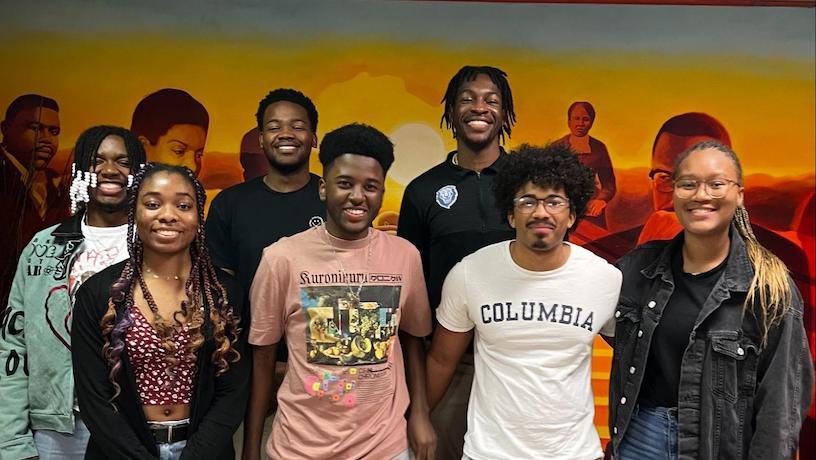 Seven members of Columbia's NSBE chapter smile for a photo