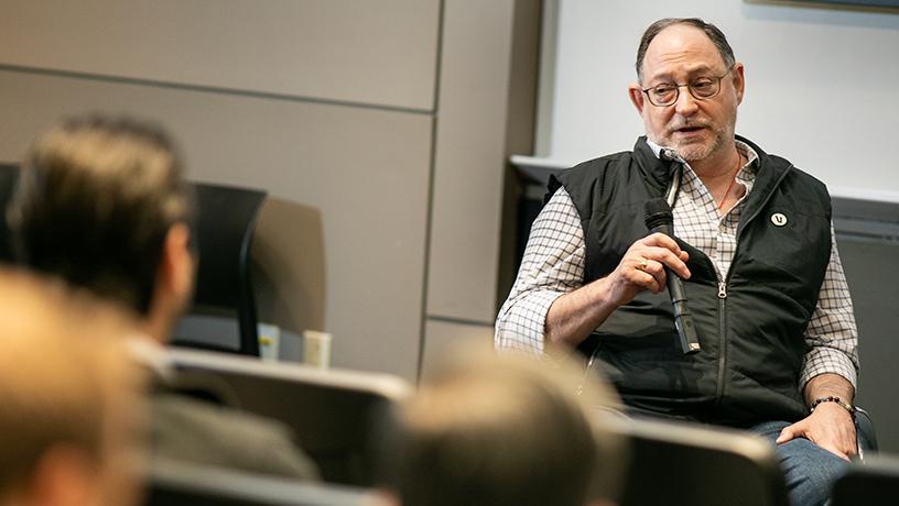 Michael A. Pucker holding a microphone