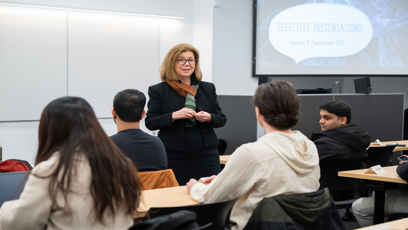 Georgia Papathomas standing in front of the room with students