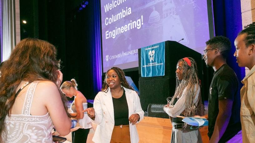 Columbia Engineering alum Deborah Owolabi speaking with incoming students in front of a stage